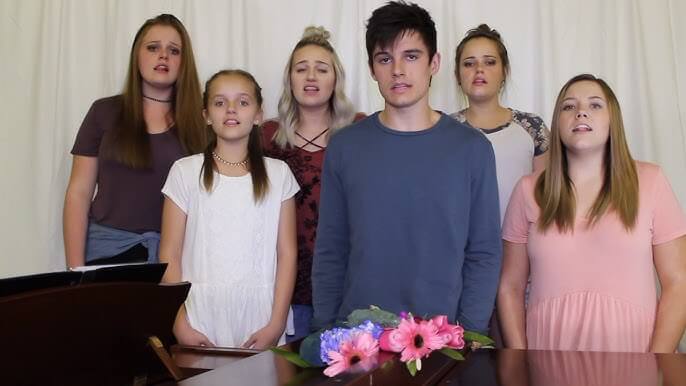 Kenny-Holland-with-his-sister-Capri-Holland-and-four-other-sisters-performing-a-song-for-his-YouTube-subscribers.-