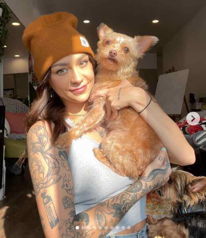 Image - Andrea Russett with her cute brown pet dog, Teddy. 